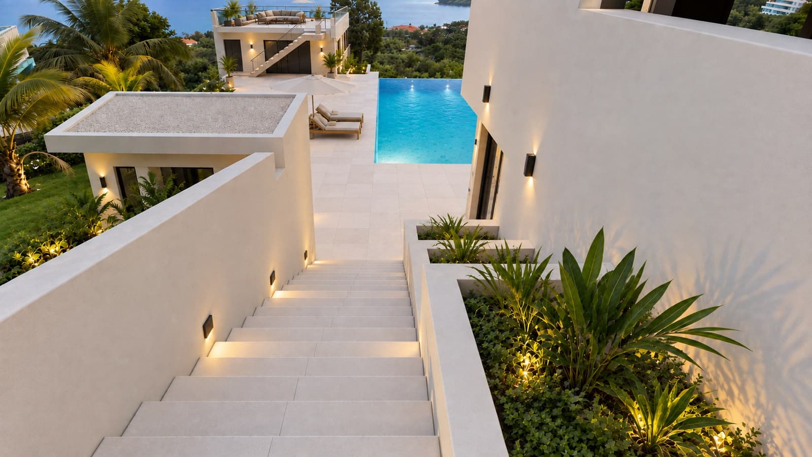 Illuminated stairway leading down to the pool deck